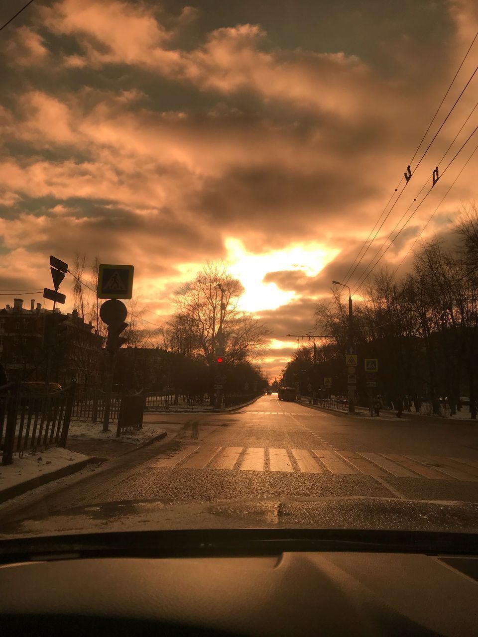 ROAD AGAINST SKY SEEN THROUGH CAR WINDSHIELD