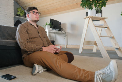 Portrait of young man sitting on chair