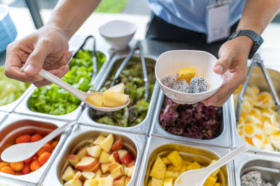 Midsection of man preparing food on table