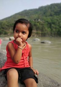 Portrait of cute girl sitting in water