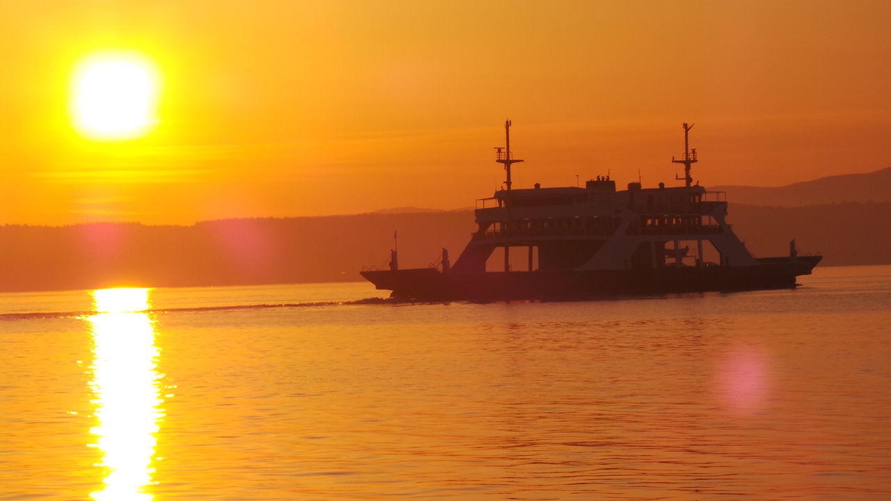 sunset, water, sun, nautical vessel, orange color, transportation, sea, mode of transport, boat, waterfront, silhouette, scenics, beauty in nature, sky, reflection, tranquil scene, idyllic, nature, tranquility, sailboat