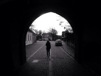 Full length of woman walking in tunnel