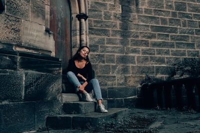 Young woman sitting on steps