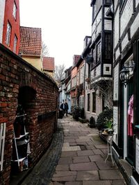 Empty alley amidst buildings in city