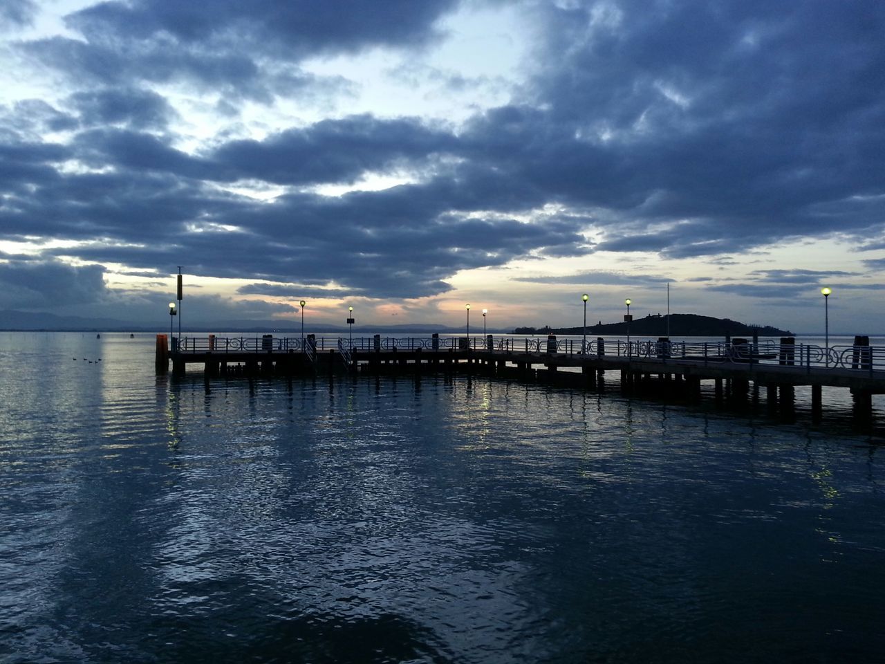 water, sky, waterfront, cloud - sky, sea, pier, cloudy, tranquility, tranquil scene, scenics, built structure, cloud, nature, beauty in nature, dusk, reflection, weather, overcast, rippled, architecture