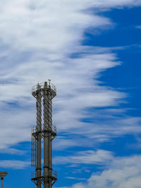 Low angle view of communications tower against sky