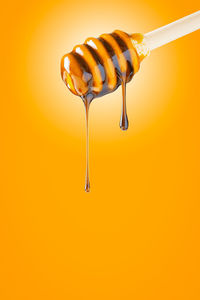 Close-up of fresh orange pepper against white background