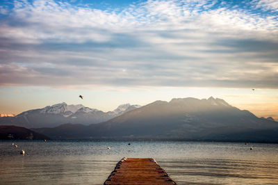 Scenic view of sea and mountains against sky