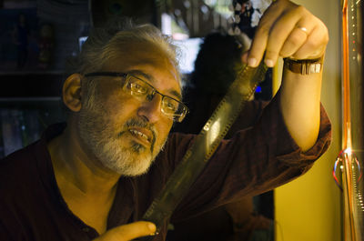 Close-up of man holding film reel