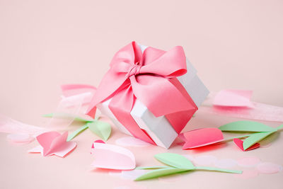 White gift box against pink background