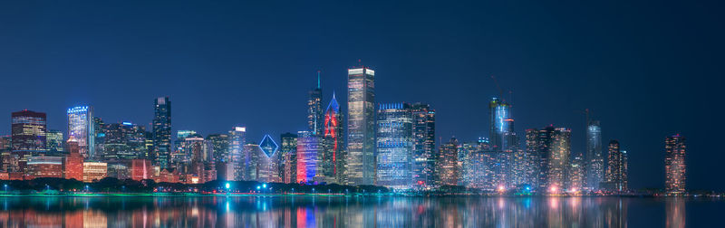 Illuminated buildings against sky at night