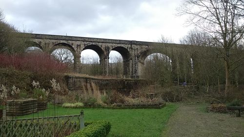 Bridge against cloudy sky