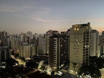 High angle view of illuminated buildings in city against sky