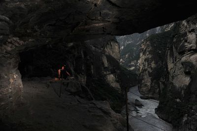 People on rock by mountain