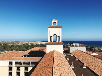 Built structure by sea against clear sky