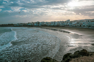 Scenic view of beach against sky during sunset