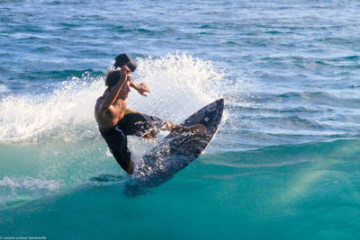 People surfing in sea
