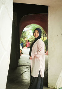 Portrait of young woman standing in tunnel