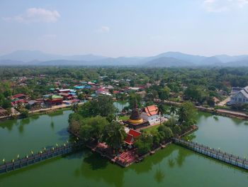 High angle view of lake and buildings against sky