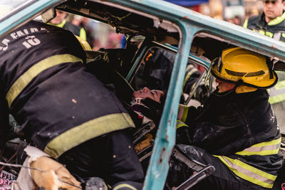 Firefighters rescuing woman from car