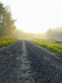 Empty road passing through field