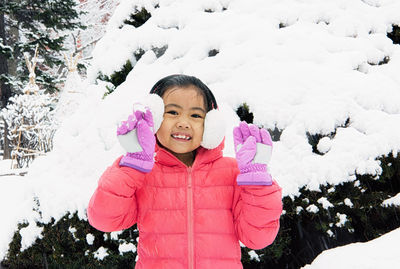 Portrait of cute girl smiling outdoors during winter