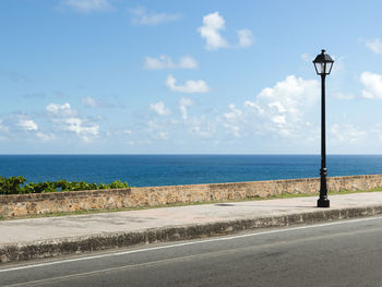 City coast mural street with a lamp post and the ocean in the background from puerto rico san juan