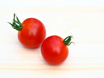 Close-up of tomatoes over white background