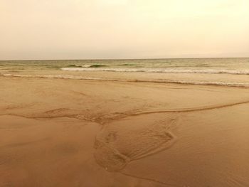 Scenic view of beach against clear sky