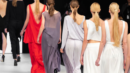 Rear view of women standing in row