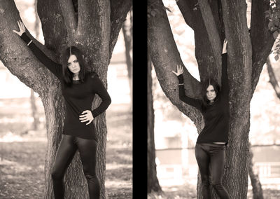 Midsection of woman standing by tree trunk