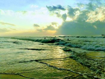 Scenic view of beach against sky during sunset