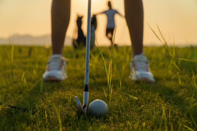 Low section of person playing with ball on grass