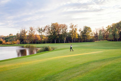 Scenic view of golf course against sky