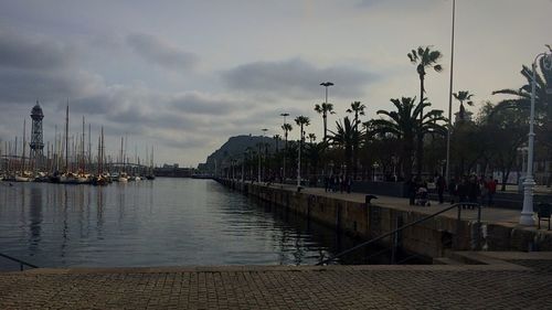 View of harbor against cloudy sky