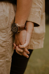 Midsection of woman holding hands