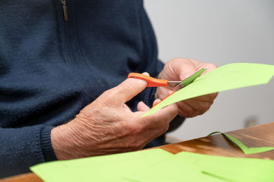 Midsection of woman holding tape measure