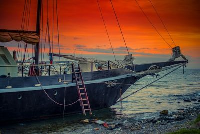 Sailboat in sea at sunset