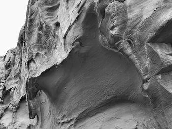 Black and white close up of the underside of a large rock formation