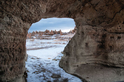 Scenic view of rock formations against sky during winter