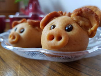 Close-up of piggy shaped moon cakes with chinese tea on table