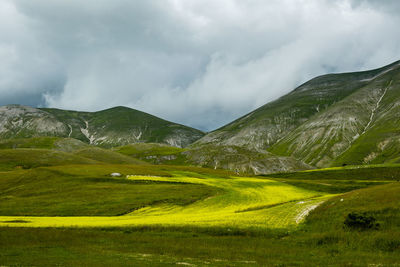 Scenic view of landscape against sky in castelluccio, umbria 