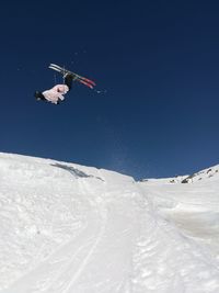 Low angle view of a backflip on skis
