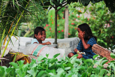 Woman sitting on plants