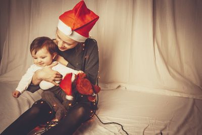 Mother holding baby at christmas time