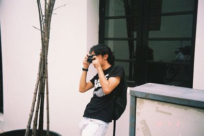 Young man photographing