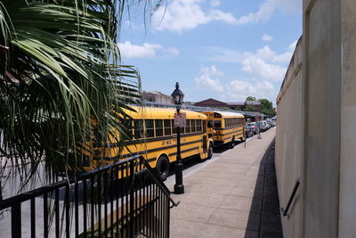 Vehicles parked by footpath in city