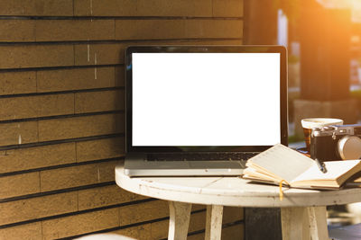 Close-up of laptop with blank screen at sidewalk cafe