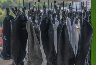 Close-up of clothes hanging in rack at store