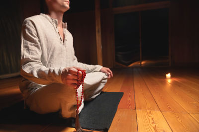 Man sitting on wooden floor at home